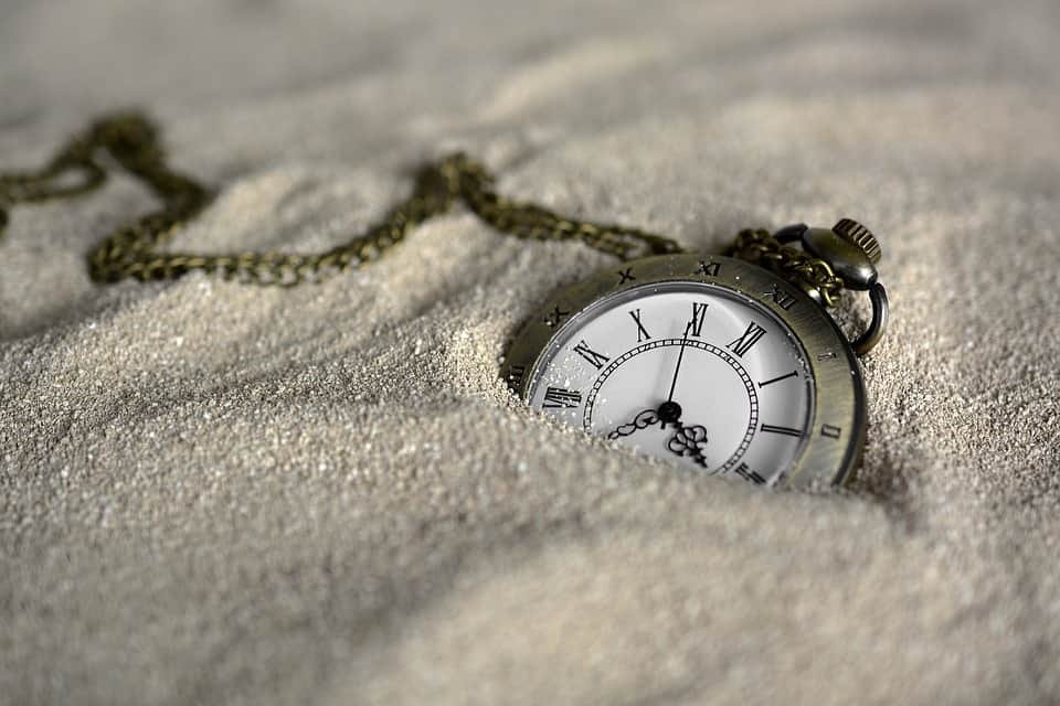 a pocketwatch in the sand...