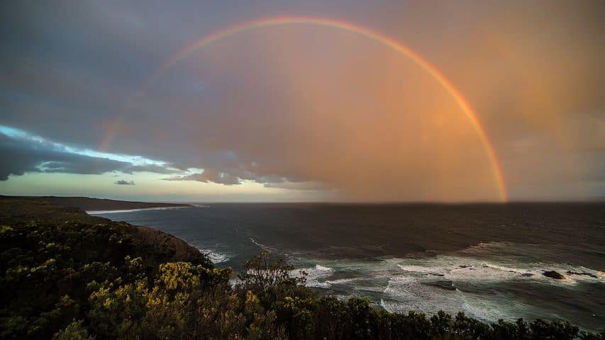 hope in the form of a rainbow over the ocean...