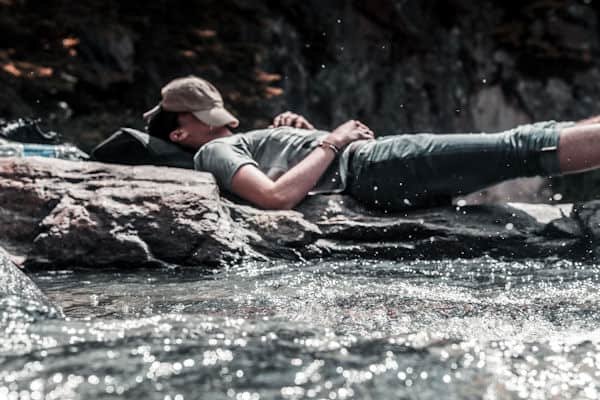 a person sleeping near a river...Photo by Hamza Bounaim on Unsplash