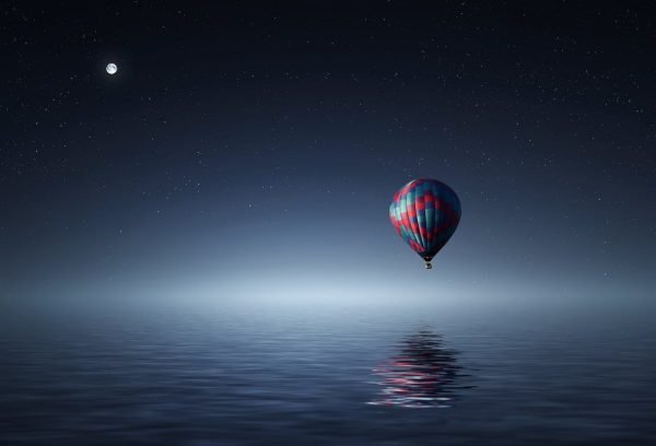 a hot air balloon floating at night...